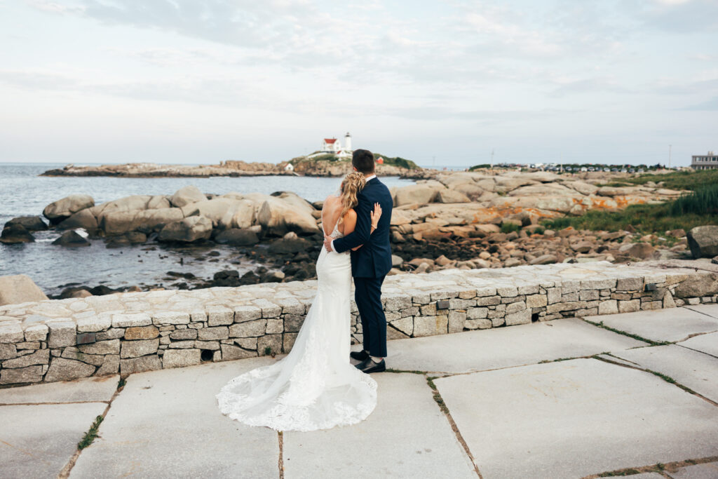 bride and groom overlooking a lighthouse at the Viewpoint Hotel Wedding Venue